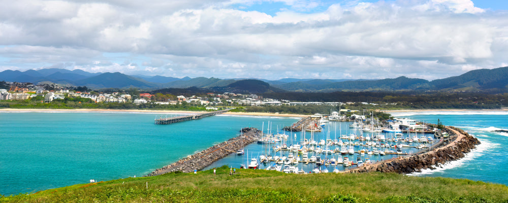 Coffs Harbour marina and jetty below green mountains, New South Wales - fine art photography print by Adam Gormley