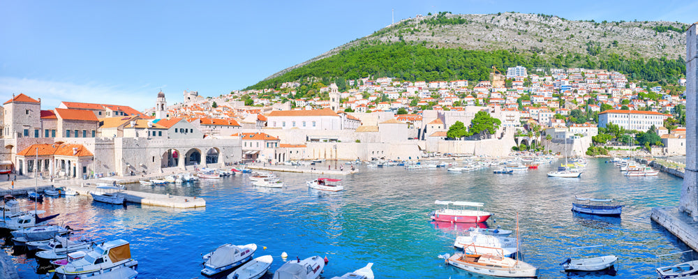 Boats in the old harbour beneath the walls of Dubrovnik Old Town, Croatia - fine art photography print by Adam Gormley