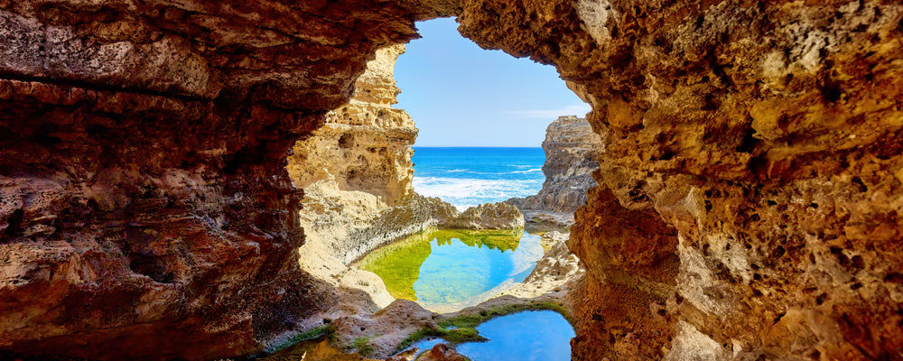 Limestone window over a rock pool at The Grotto, Great Ocean Road, Victoria - fine art photography print by Adam Gormley