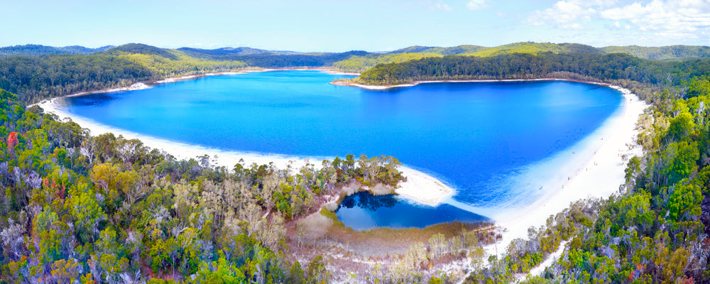 Aerial view of Lake McKenzie ringed by white sand and forest, K'gari (Fraser Island), Queensland - fine art photography print by Adam Gormley
