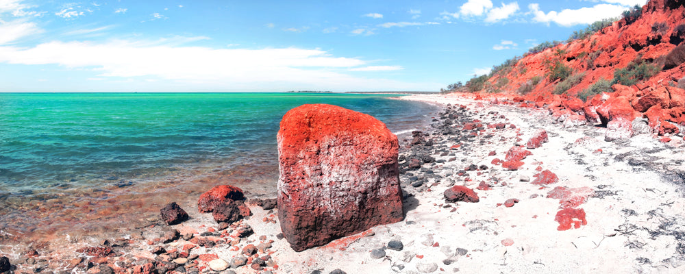 Red boulder on the beach with turquoise water at Monkey Mia, Shark Bay, Western Australia - fine art photography print by Adam Gormley
