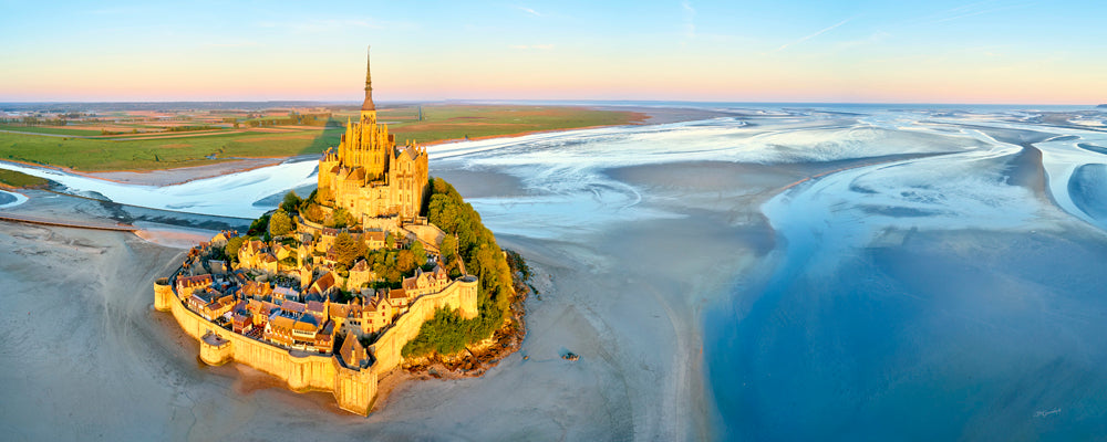 Aerial view of Mont-Saint-Michel and its tidal flats in morning light, Normandy, France - fine art photography print by Adam Gormley