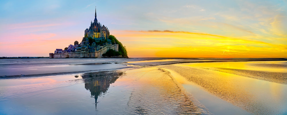 Mont-Saint-Michel reflected in the wet sand under a golden sky, Normandy, France - fine art photography print by Adam Gormley