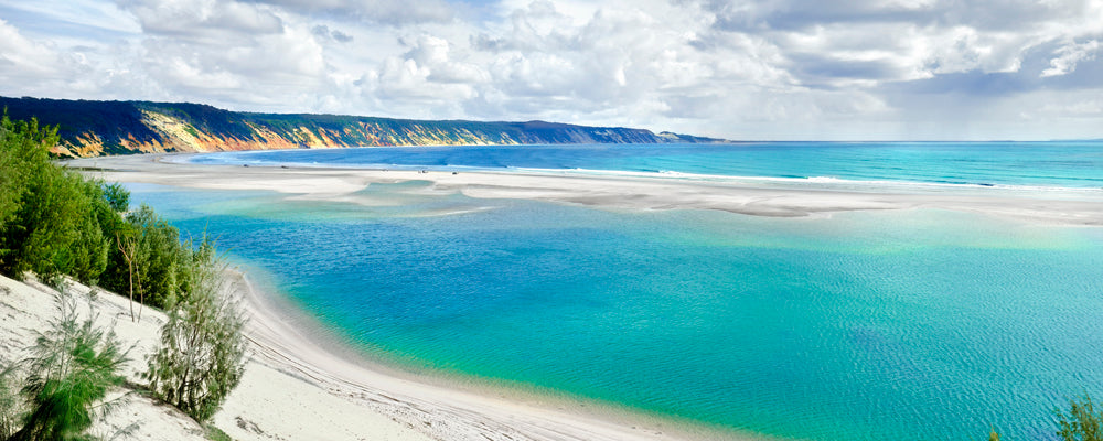 Turquoise lagoon and coloured sand cliffs at Rainbow Beach, Queensland - fine art photography print by Adam Gormley