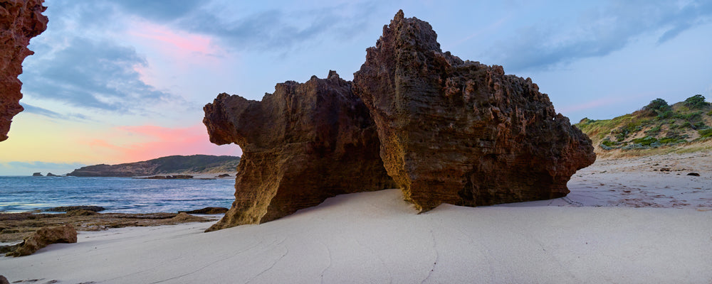 Weathered rock formations on white sand at Sorrento ocean beach, Victoria - fine art photography print by Adam Gormley