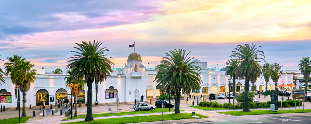 Palm trees and the St Kilda Sea Baths under a pastel sky, Melbourne, Victoria - fine art photography print by Adam Gormley