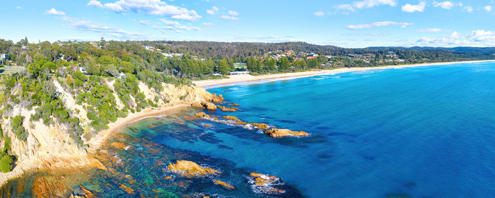 Aerial view of the headland and long beach at Tathra, New South Wales - fine art photography print by Adam Gormley