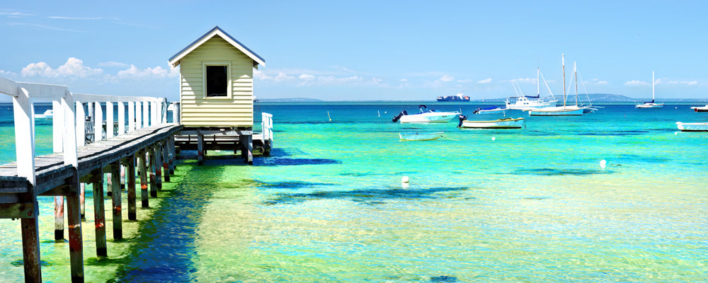 Boathouse on a timber jetty over turquoise water, Mornington Peninsula, Victoria - fine art photography print by Adam Gormley