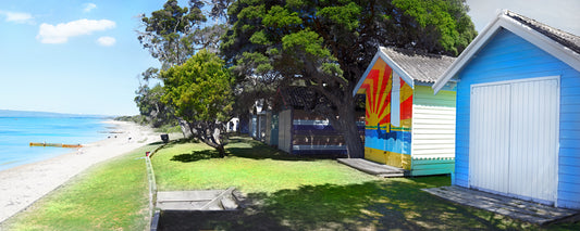 Colourful bathing boxes above a sandy beach, Mornington Peninsula, Victoria - fine art photography print by Adam Gormley