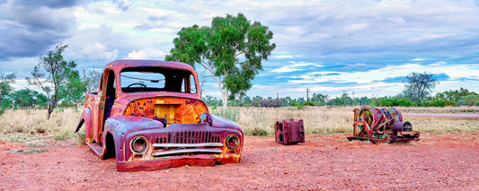 Old rusted pickup truck on red dirt in the Northern Territory outback - fine art photography print by Adam Gormley