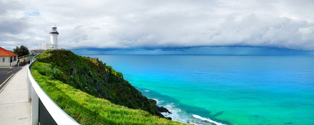 Cape Byron Lighthouse above turquoise water on a stormy day, Byron Bay, New South Wales - fine art photography print by Adam Gormley