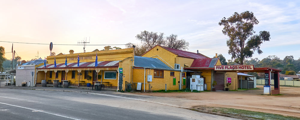 Yellow country pub with a long verandah at Campbells Creek, Victoria - fine art photography print by Adam Gormley