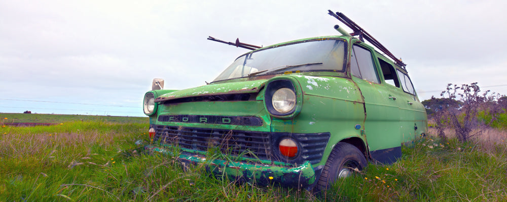 Old green van rusting in long grass near Coleraine, Victoria - fine art photography print by Adam Gormley