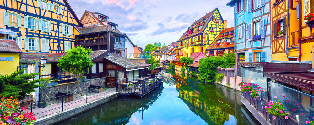 Painted houses reflected in the canal of Little Venice at sunset, Colmar, France - fine art photography print by Adam Gormley