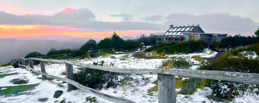 Pink and orange sunset over Craig's Hut and fresh snow, Mt Stirling, Victoria - fine art photography print by Adam Gormley