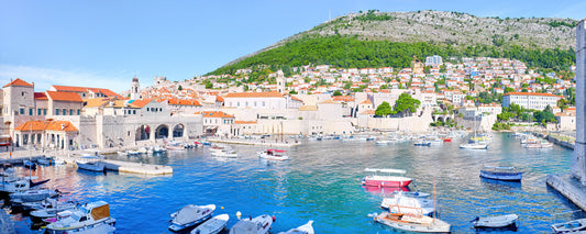 Boats in the old harbour beneath the walls of Dubrovnik Old Town, Croatia - fine art photography print by Adam Gormley
