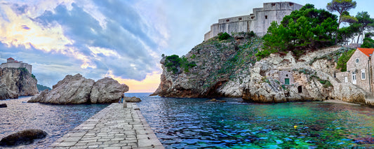 Stone pier in the cove beneath Fort Lovrijenac at dusk, Dubrovnik, Croatia - fine art photography print by Adam Gormley