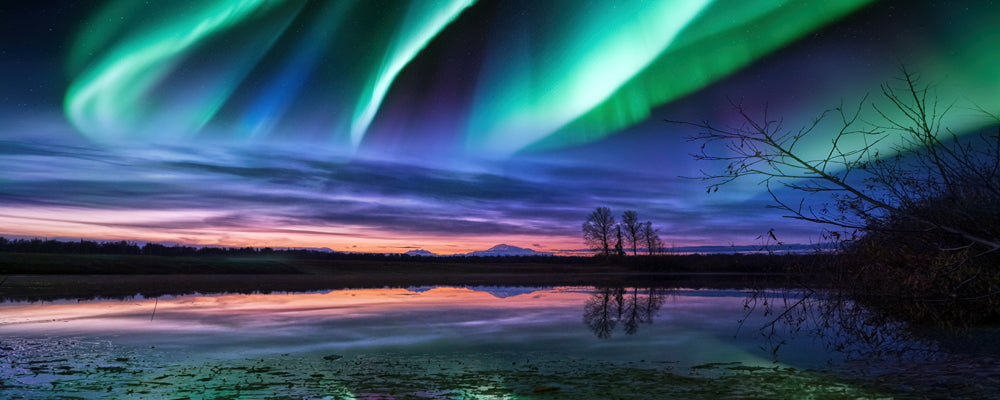 Green northern lights swirling over a still lake at dusk, Trapper Creek, Alaska - fine art photography print by Adam Gormley