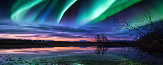 Green northern lights swirling over a still lake at dusk, Trapper Creek, Alaska - fine art photography print by Adam Gormley