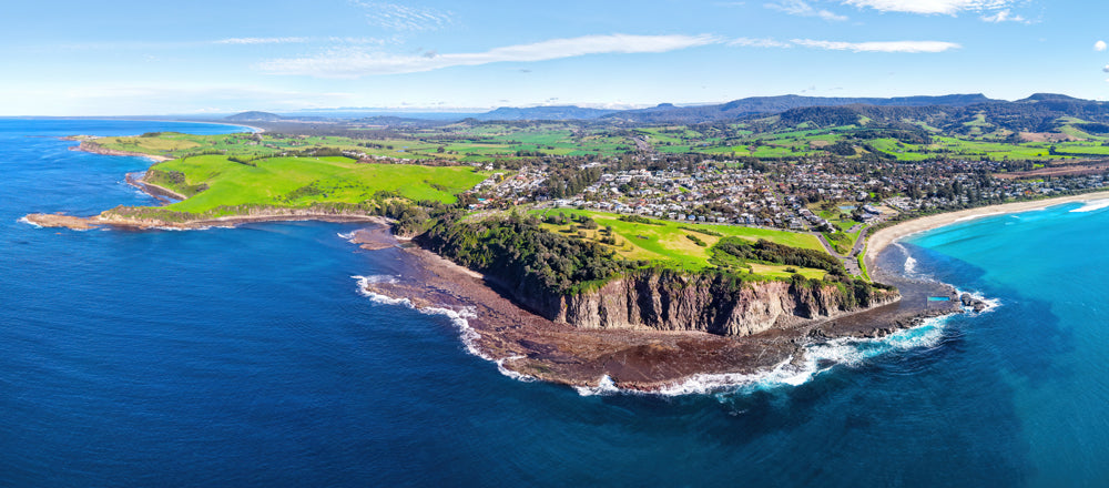 Aerial view of the green headland and beach at Gerringong, New South Wales - fine art photography print by Adam Gormley