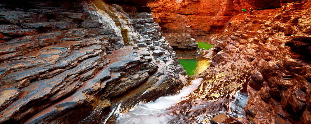 Narrow red rock walls and green pool in Hancock Gorge, Karijini National Park, Pilbara, Western Australia - fine art photography print by Adam Gormley