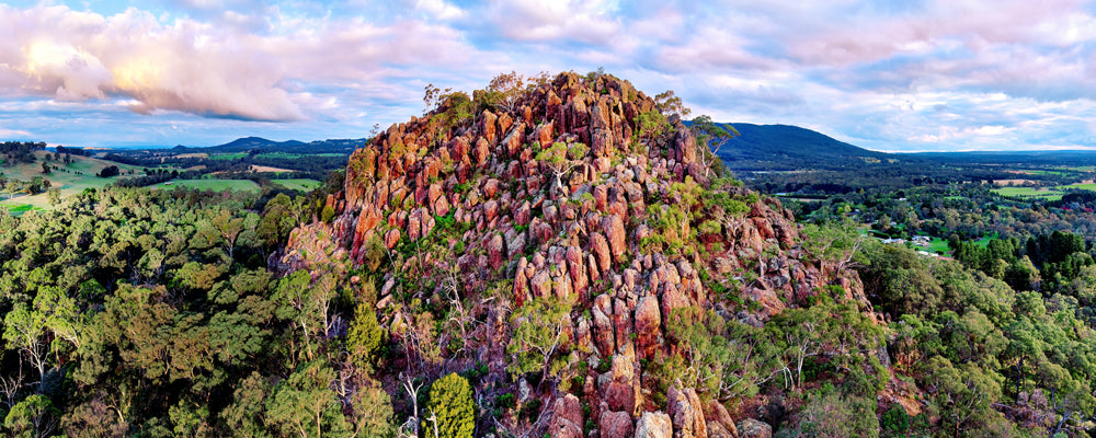Aerial view of Hanging Rock and the Macedon Ranges under a pink sky, Victoria - fine art photography print by Adam Gormley
