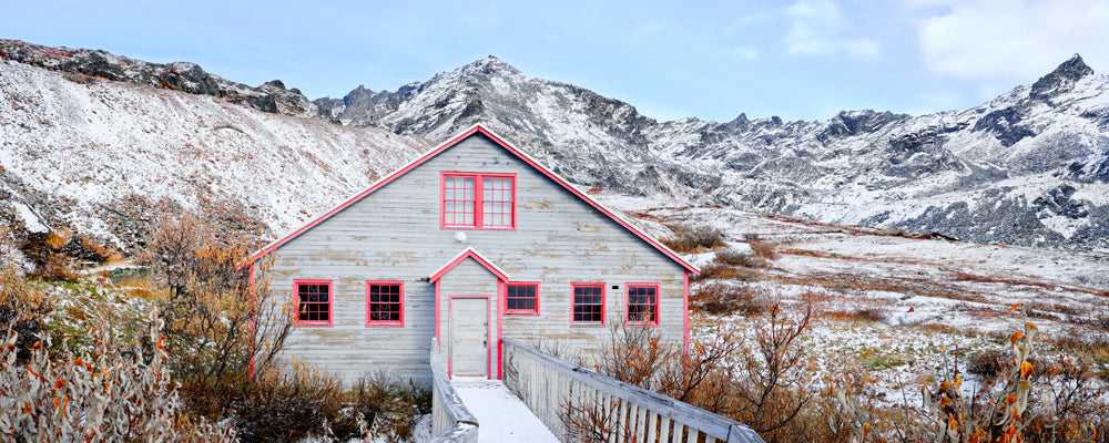Weathered timber building at Independence Mine below snowy peaks, Hatcher Pass, Alaska - fine art photography print by Adam Gormley