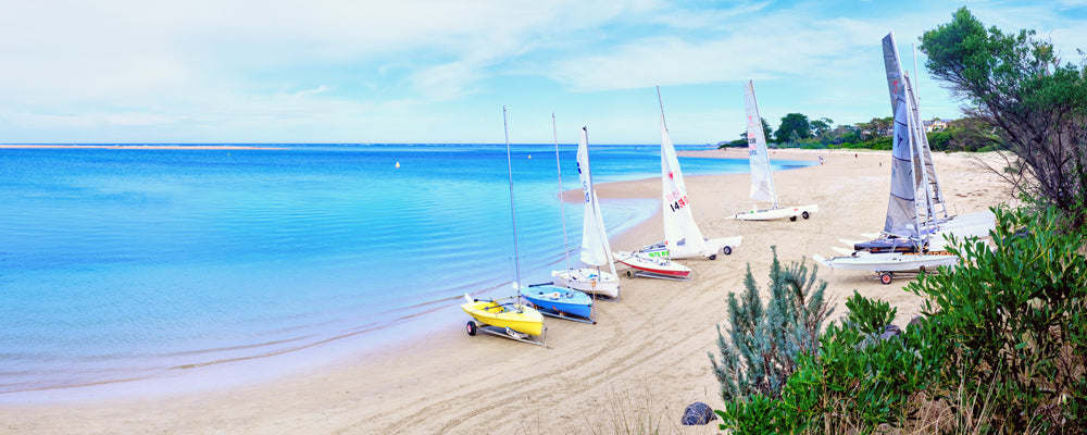 Colourful catamarans on the sand at Inverloch, Victoria - fine art photography print by Adam Gormley
