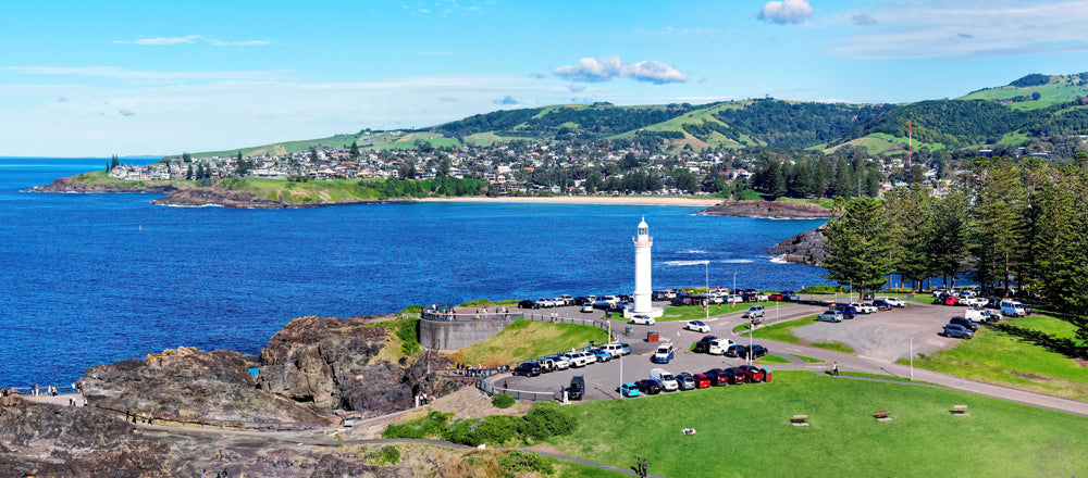 Kiama Lighthouse on Blowhole Point with the town behind, New South Wales - fine art photography print by Adam Gormley