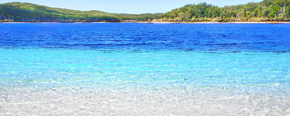 Clear turquoise and blue water at Lake McKenzie, K'gari (Fraser Island), Queensland - fine art photography print by Adam Gormley