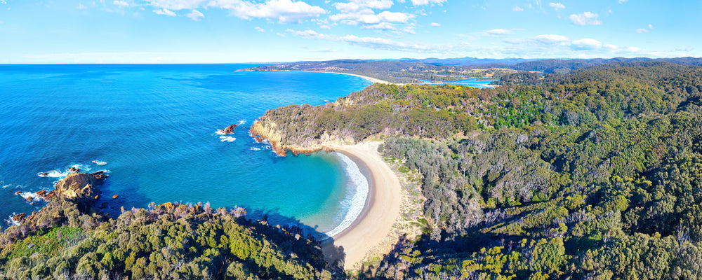 Aerial view of the crescent beach at Moon Bay near Bermagui, New South Wales - fine art photography print by Adam Gormley