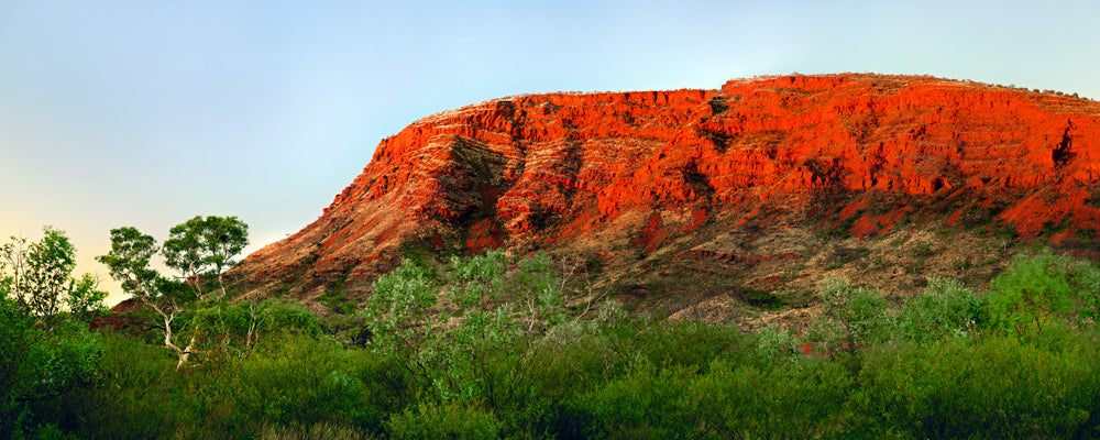 Red cliffs of Mount Bruce glowing at sunset, Karijini National Park, Pilbara, Western Australia - fine art photography print by Adam Gormley