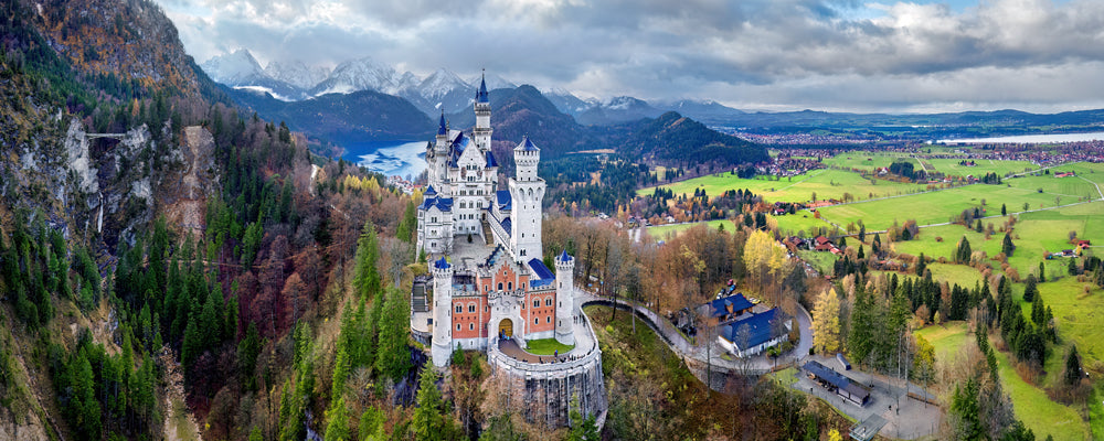 Aerial view of Neuschwanstein Castle surrounded by autumn forest, Bavaria, Germany - fine art photography print by Adam Gormley