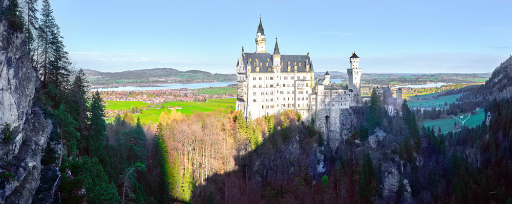 Neuschwanstein Castle on its rocky ridge in bright sunshine, Bavaria, Germany - fine art photography print by Adam Gormley
