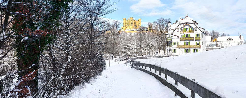 Hohenschwangau Castle above a snowy lane, Bavaria, Germany - fine art photography print by Adam Gormley