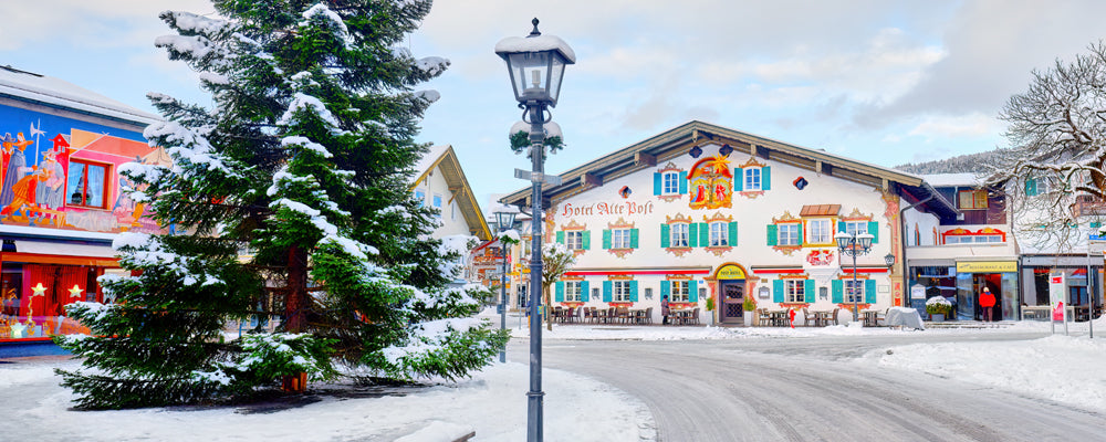 Painted houses and a snowy Christmas tree in Oberammergau, Bavaria, Germany - fine art photography print by Adam Gormley
