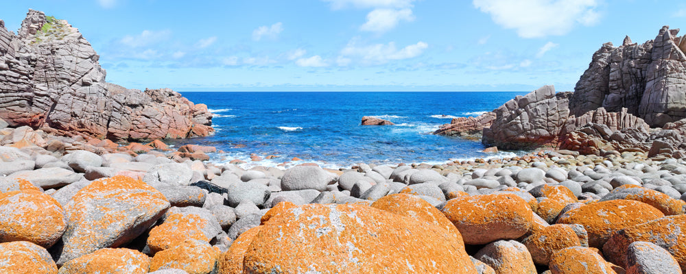 Orange lichen-covered granite boulders on the coast of Phillip Island, Victoria - fine art photography print by Adam Gormley