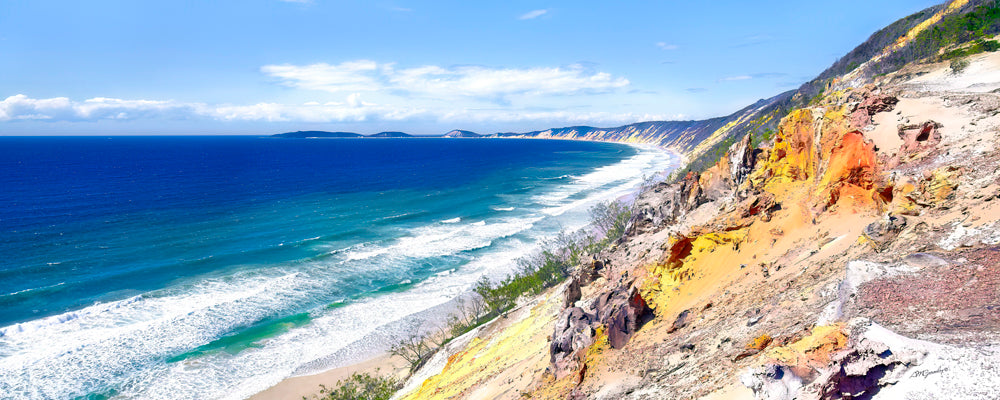 Coloured sand cliffs above deep blue surf, Rainbow Beach, Queensland - fine art photography print by Adam Gormley