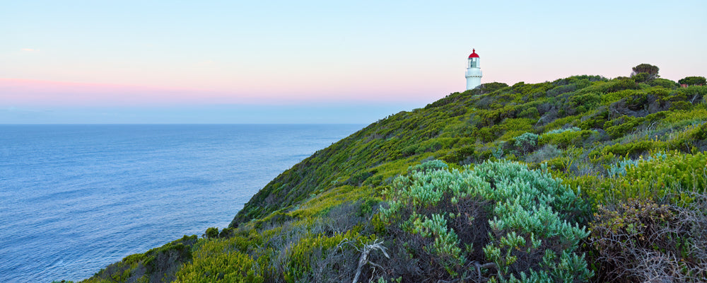 Cape Schanck lighthouse on a green headland under a pastel sky, Victoria - fine art photography print by Adam Gormley