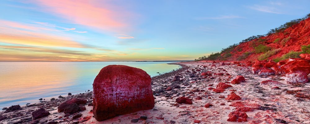 Sunrise over red rocks and still water at Monkey Mia, Shark Bay, Western Australia - fine art photography print by Adam Gormley