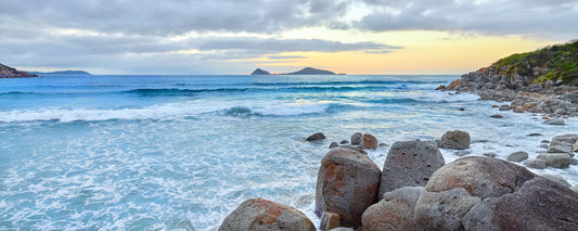 Waves over granite rocks with islands on the horizon, Wilsons Promontory, Victoria - fine art photography print by Adam Gormley